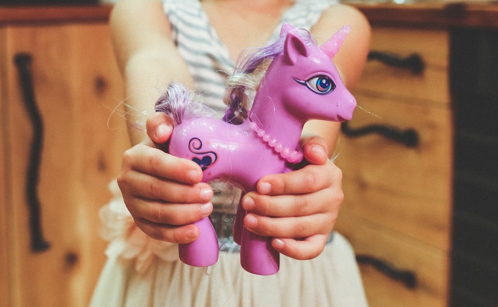 girl showing a toy